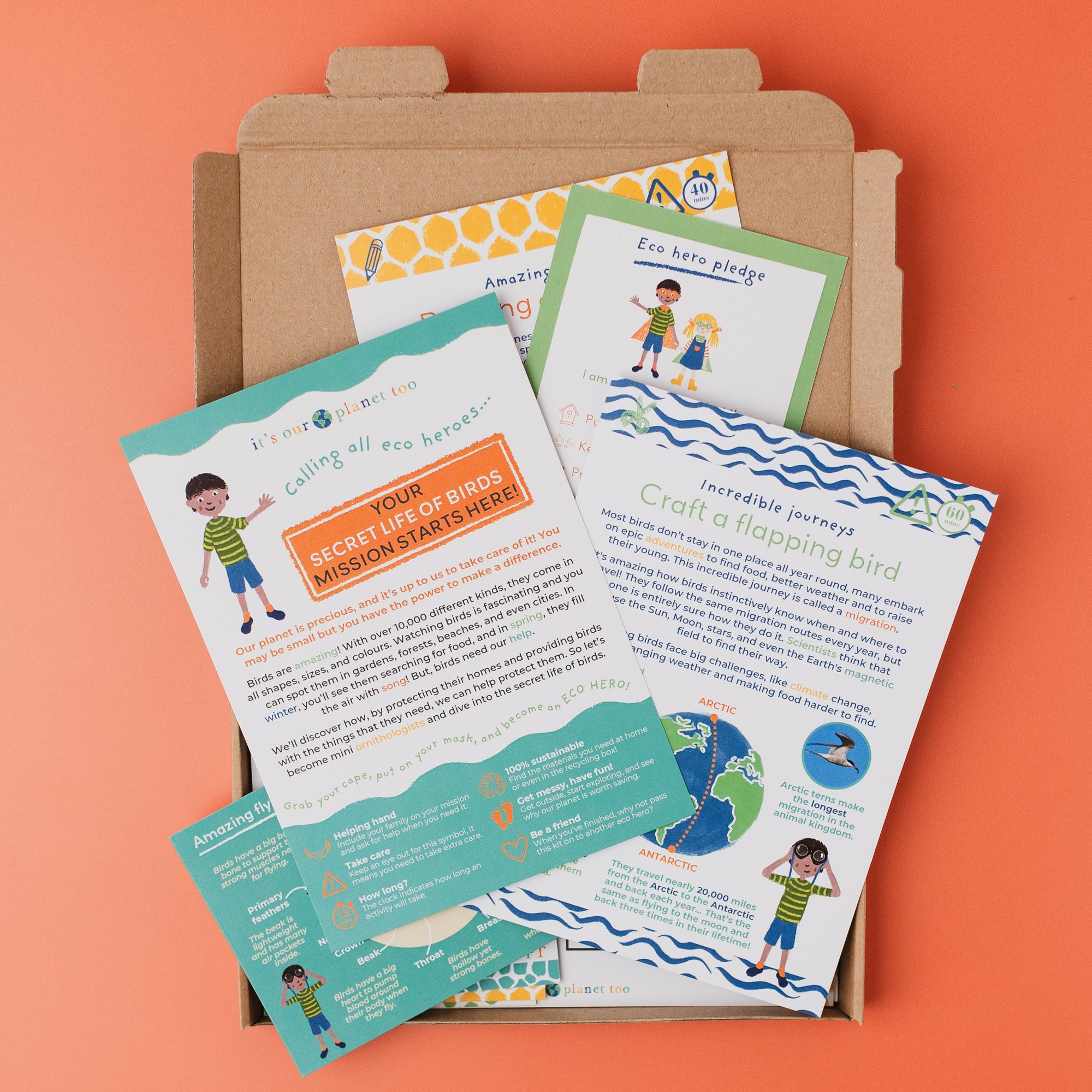 Educational materials for children on a cardboard box against an orange background