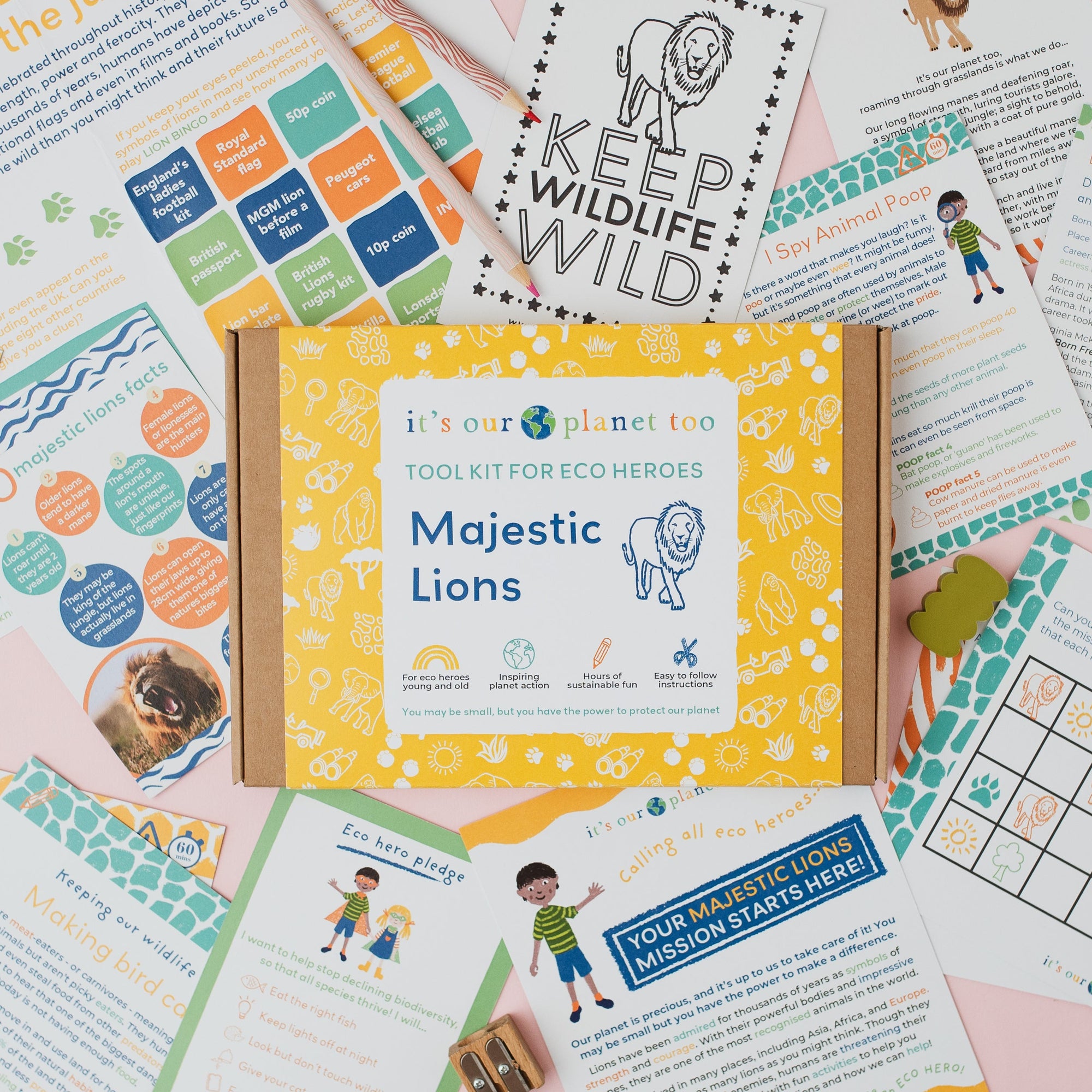 Educational materials and a box labeled 'Majestic Lions' from it's our planet too on a pink background.